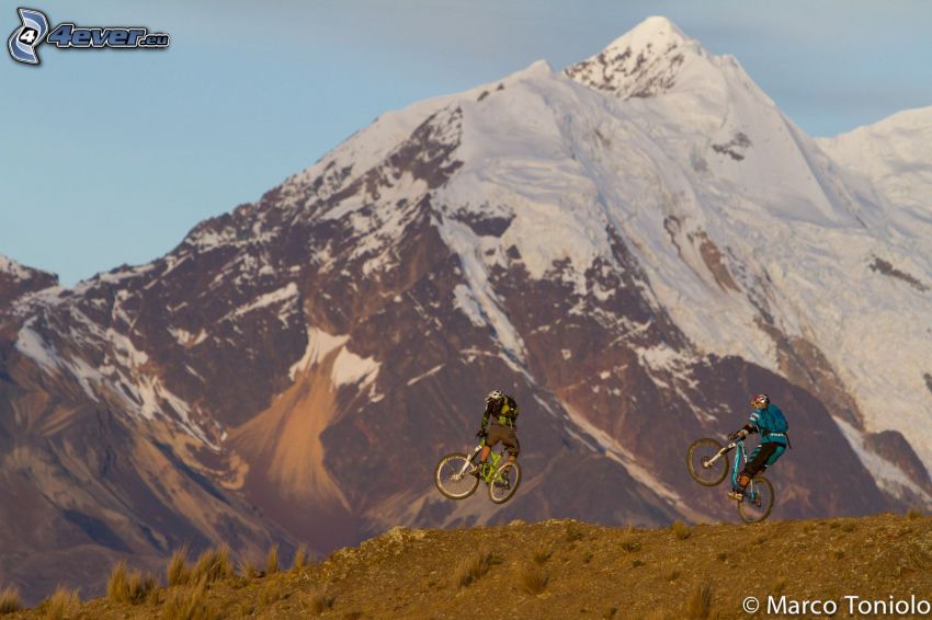 mountain biker, jump on bike, snowy mountains