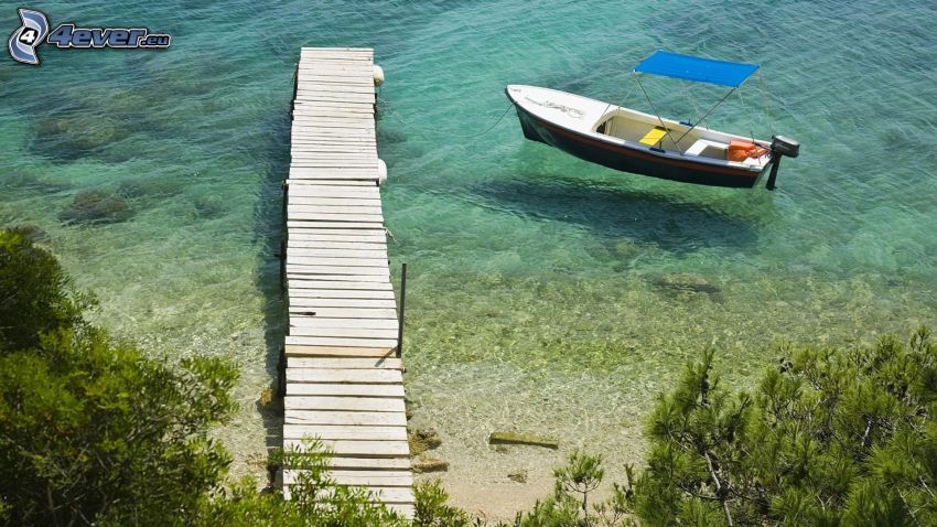 boat at shore, wooden pier, shallow azure sea