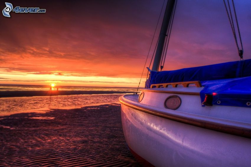 sailing boat, sunset behind the sea, orange sky