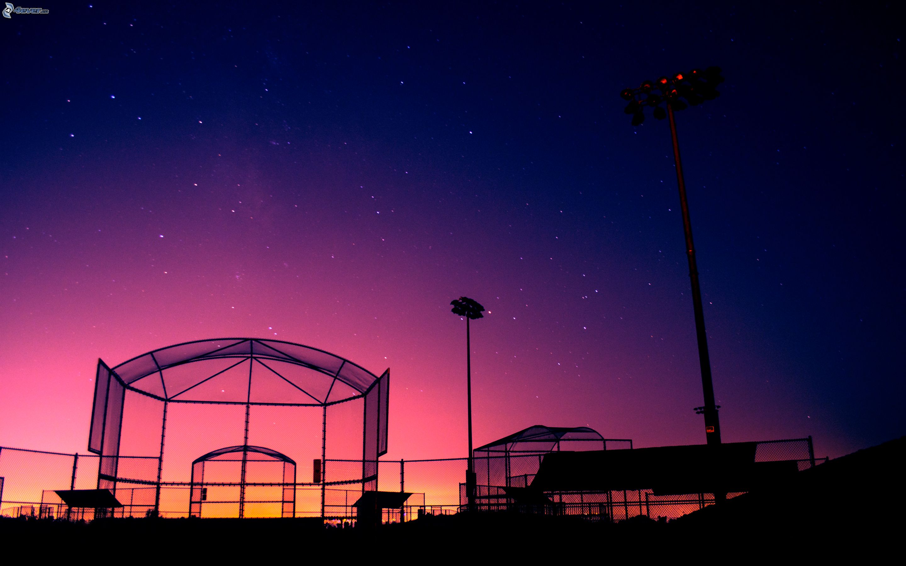 Download A Baseball Stadium With A Beautiful Sunset Wallpaper